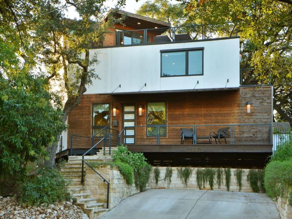 Trendy Travis Heights home offers tree house views and a touch of