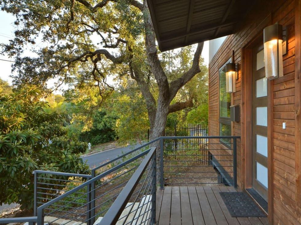 Trendy Travis Heights home offers tree house views and a touch of