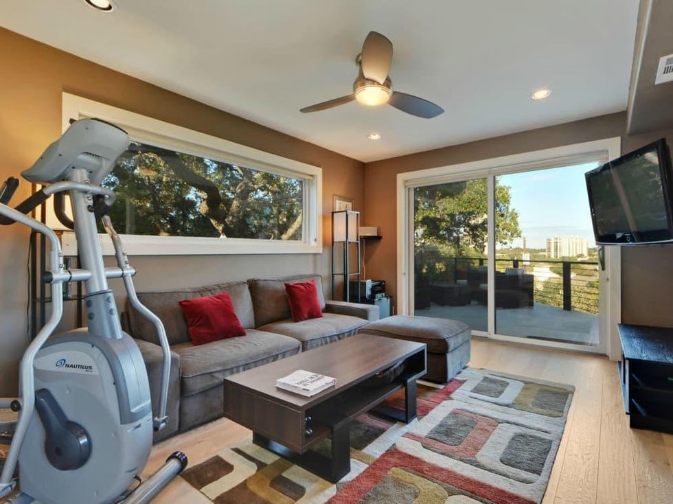 Trendy Travis Heights home offers tree house views and a touch of