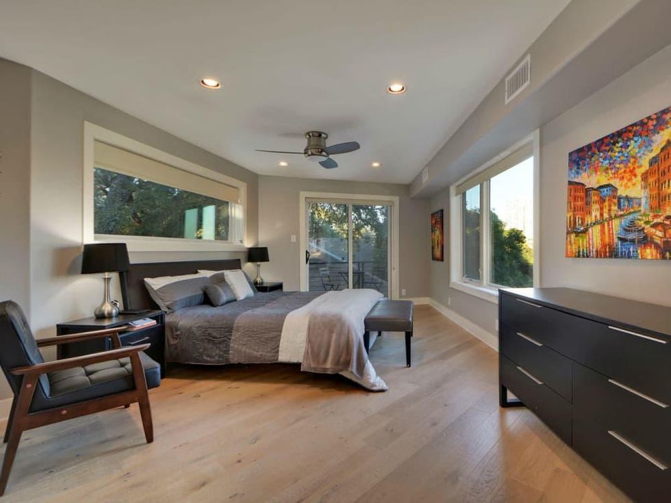 Trendy Travis Heights home offers tree house views and a touch of