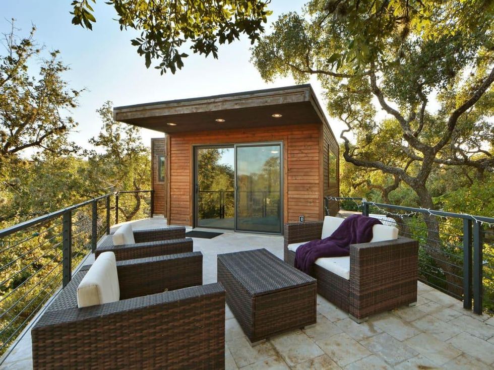 Trendy Travis Heights home offers tree house views and a touch of