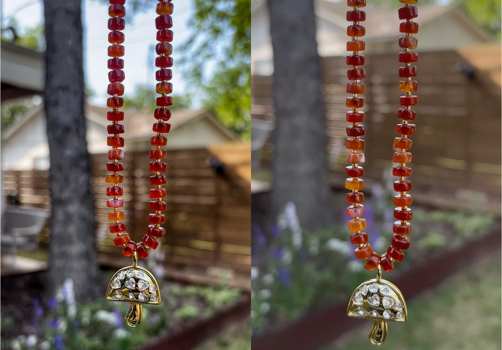 A burnt orange beaded necklace with a gold bejeweled mushroom pendant hanging at the bottom.