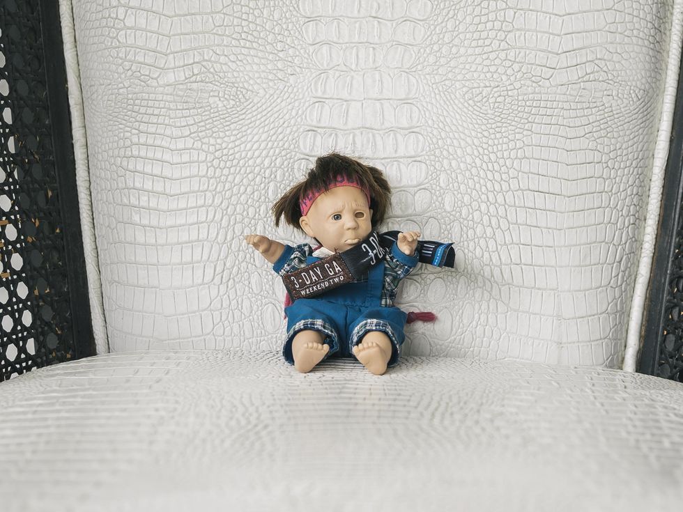 A doll wearing an Austin City Limits Festival wristband.