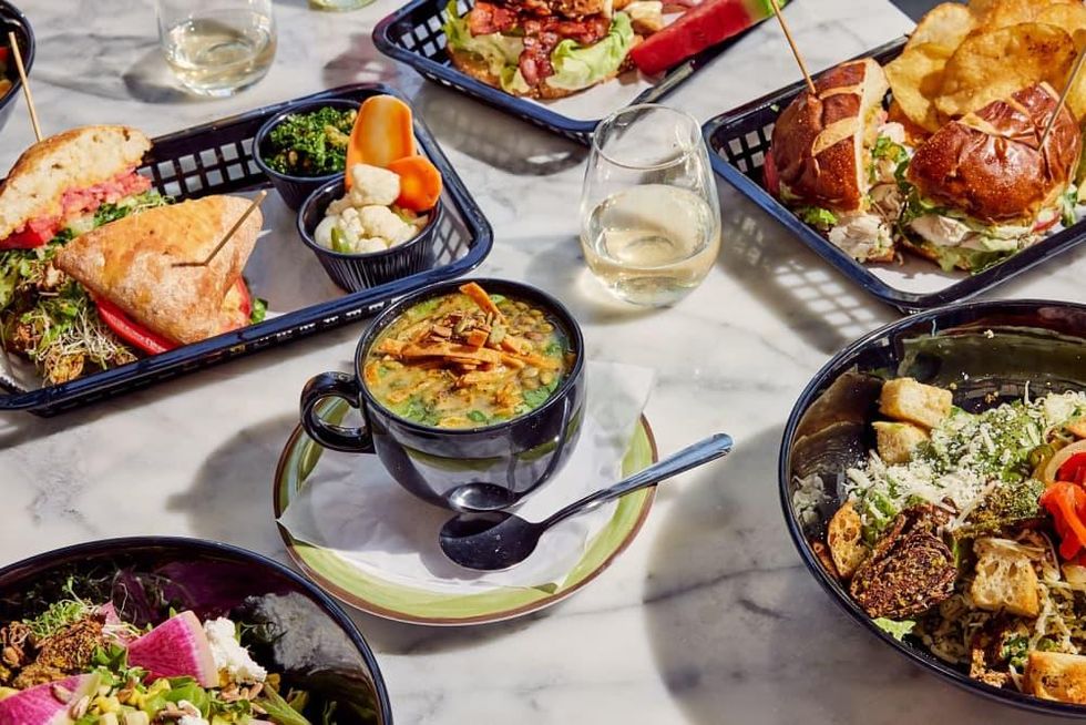 A large spread of sandwiches, salads, and sides by Local Foods.