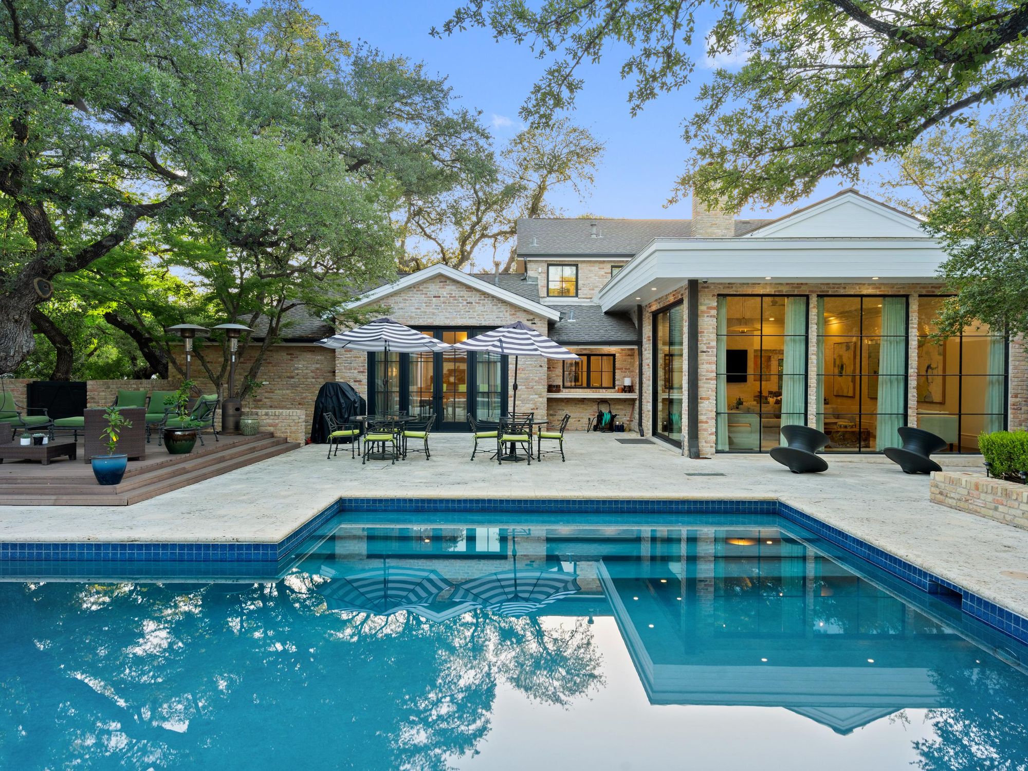 A photo of the pool and back patio area behind the main house.
