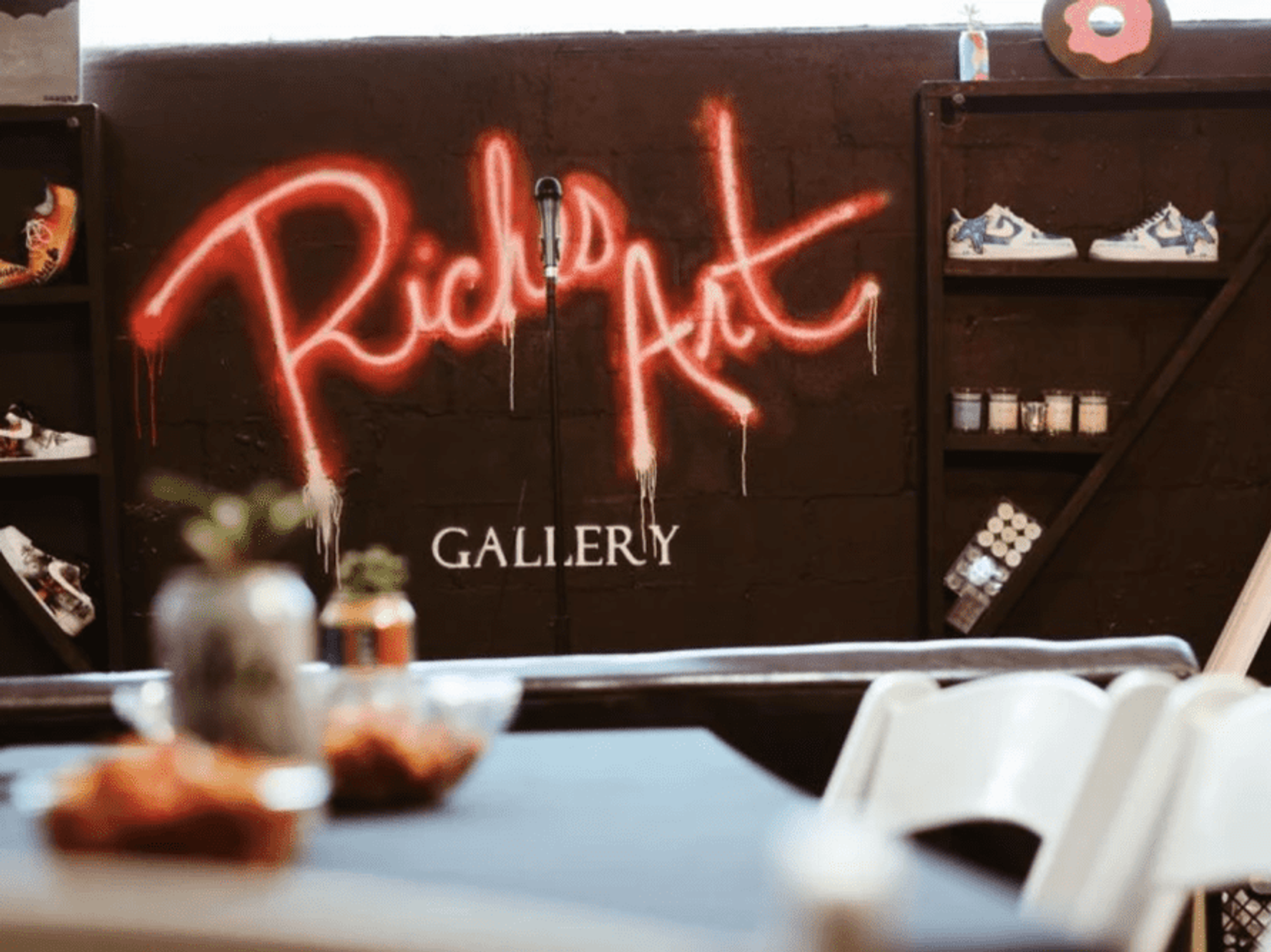A wall at RichesArt Gallery announces the name in faux neon.