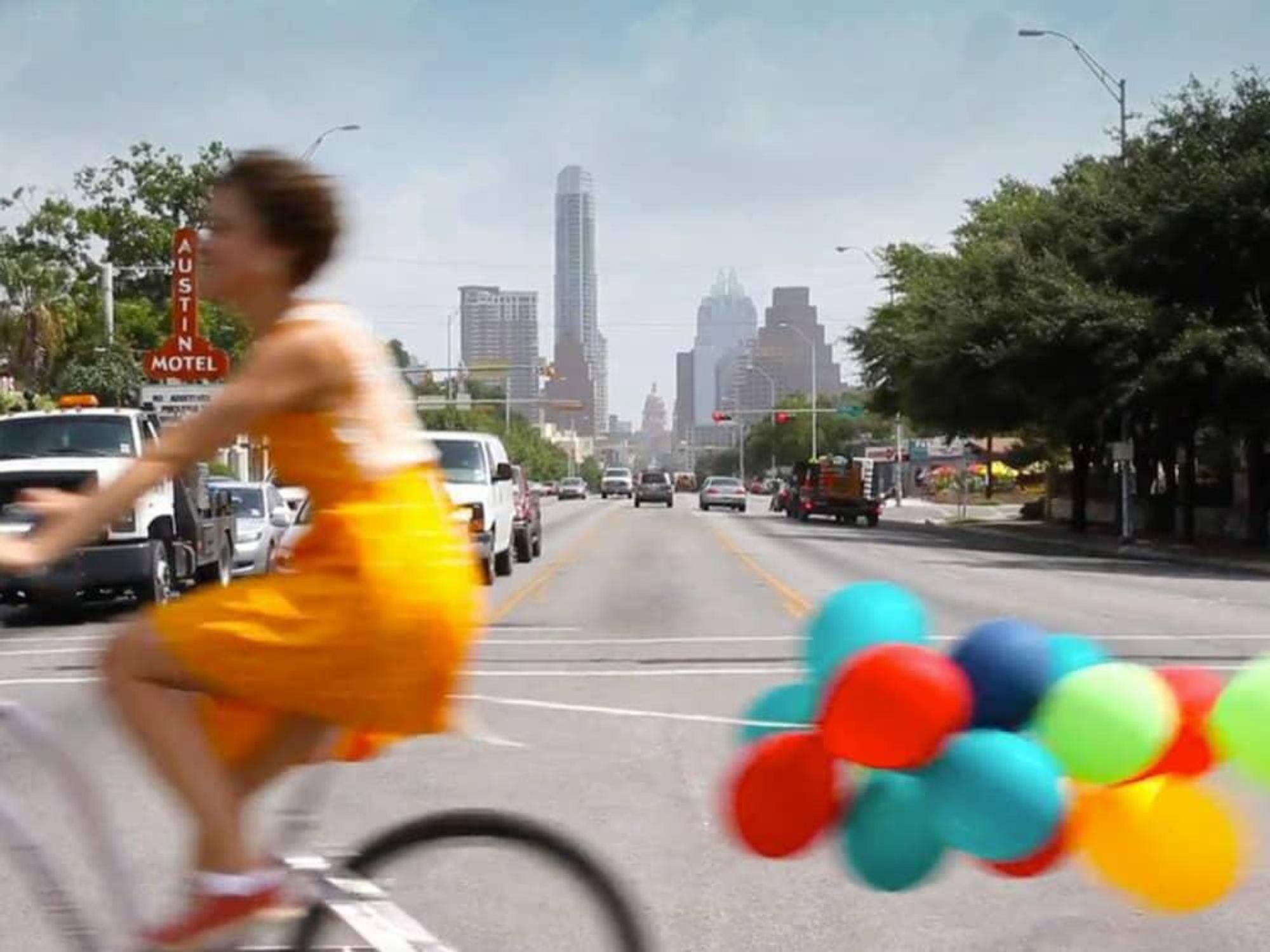 Amplify Austin funraiser woman bike bicycle baloons South Congress Avenue