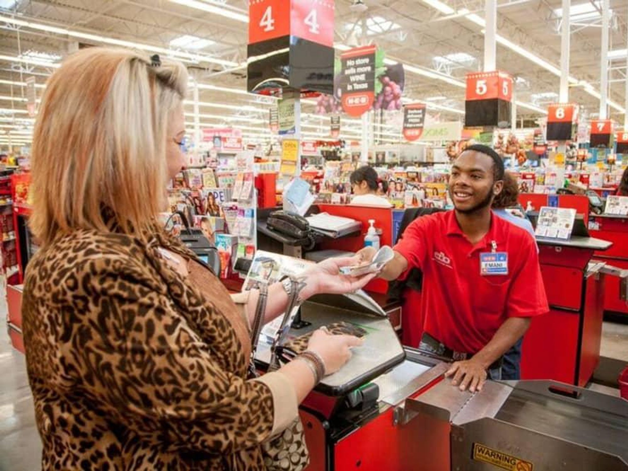 An H-E-B worker checks out a shopper