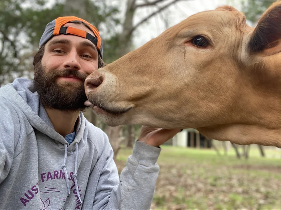 Austin Farm Sanctuary co-owner Chris Fuller-Wigg with one of the farms' many rescued cows.