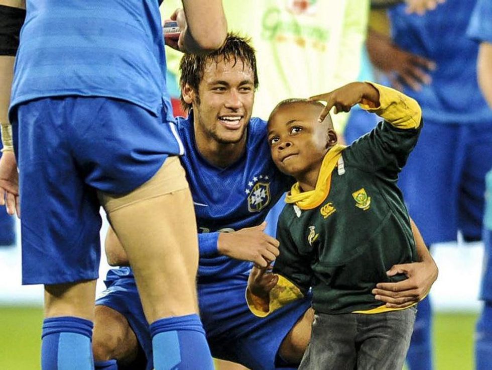 Boy with Neymar on field