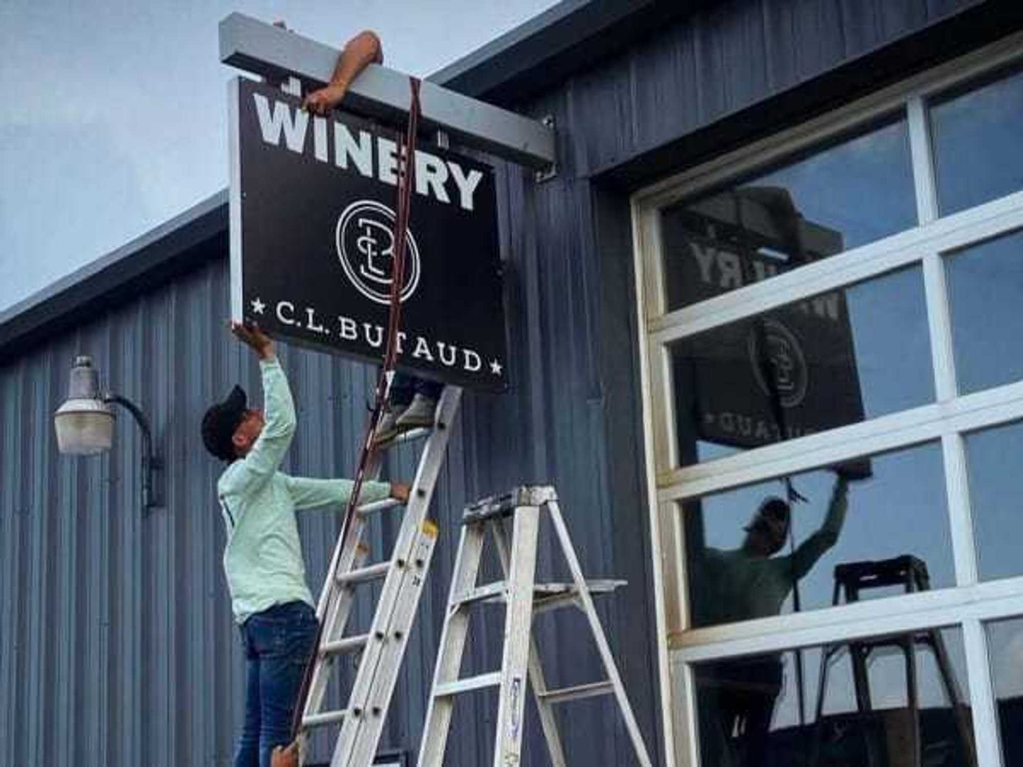 C.L. Butaud sign coming down