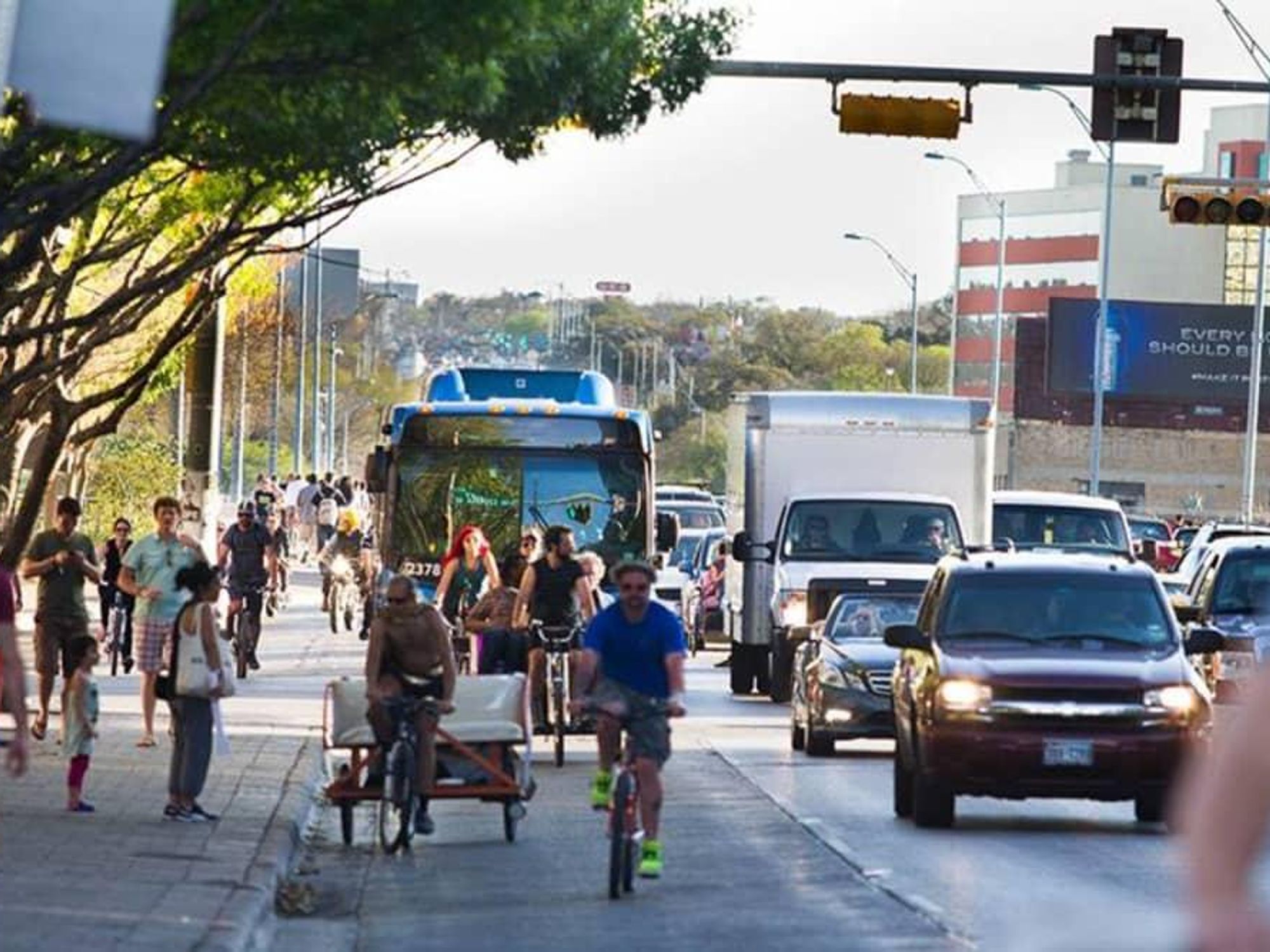 Cap metro bus cyclist busy downtown Austin street