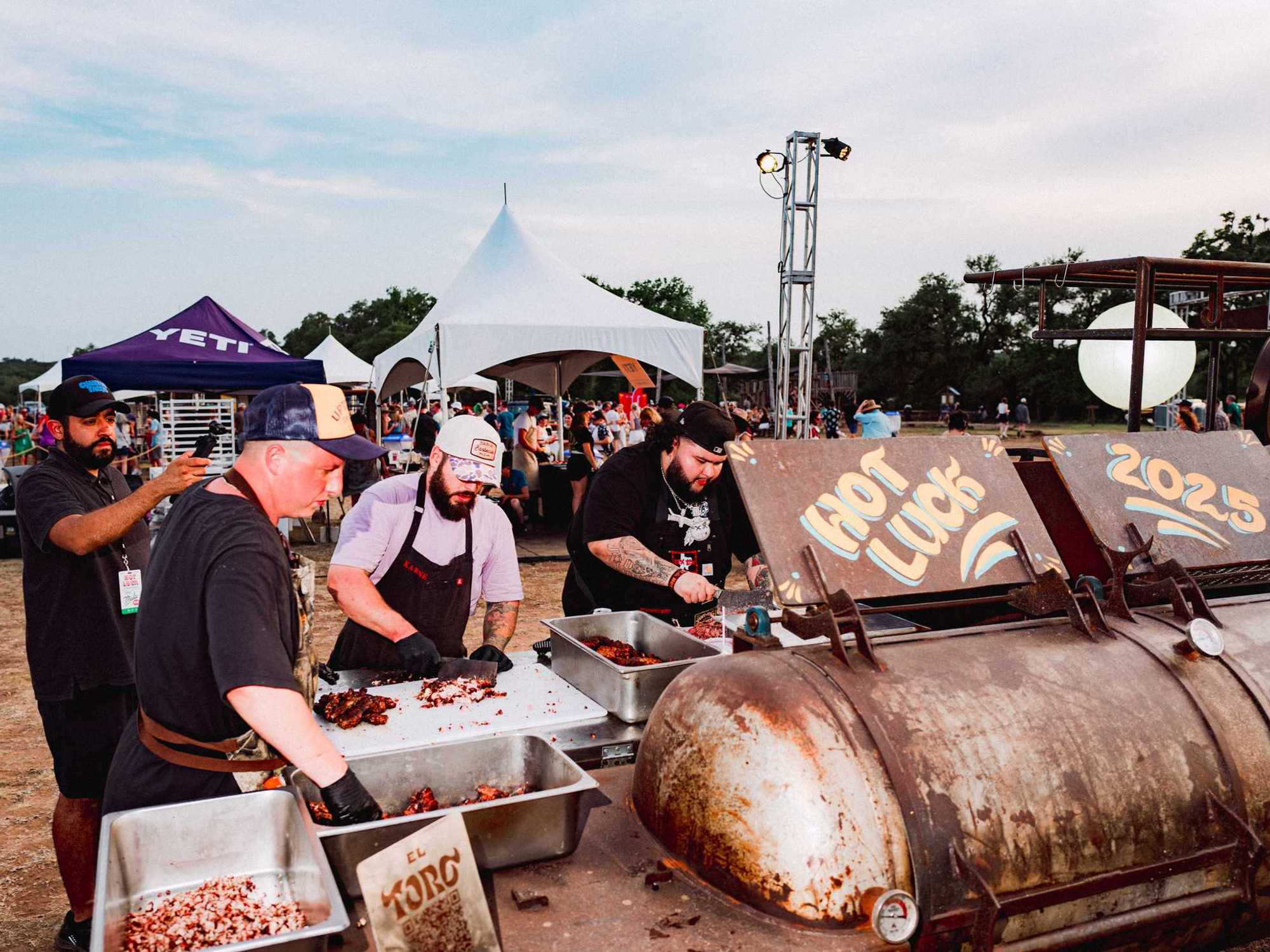 Chefs work the pit at Hot Luck 2025