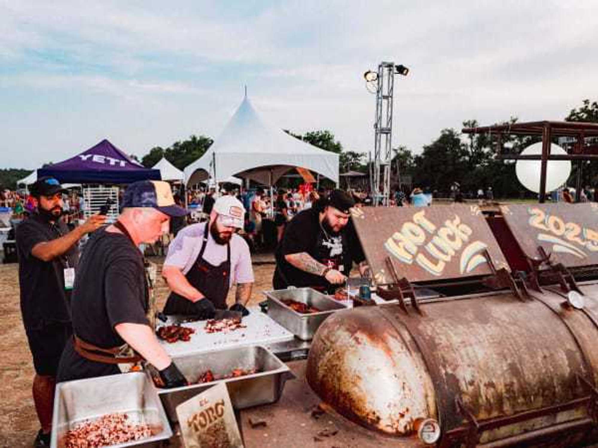 Chefs work the pit at Hot Luck 2025