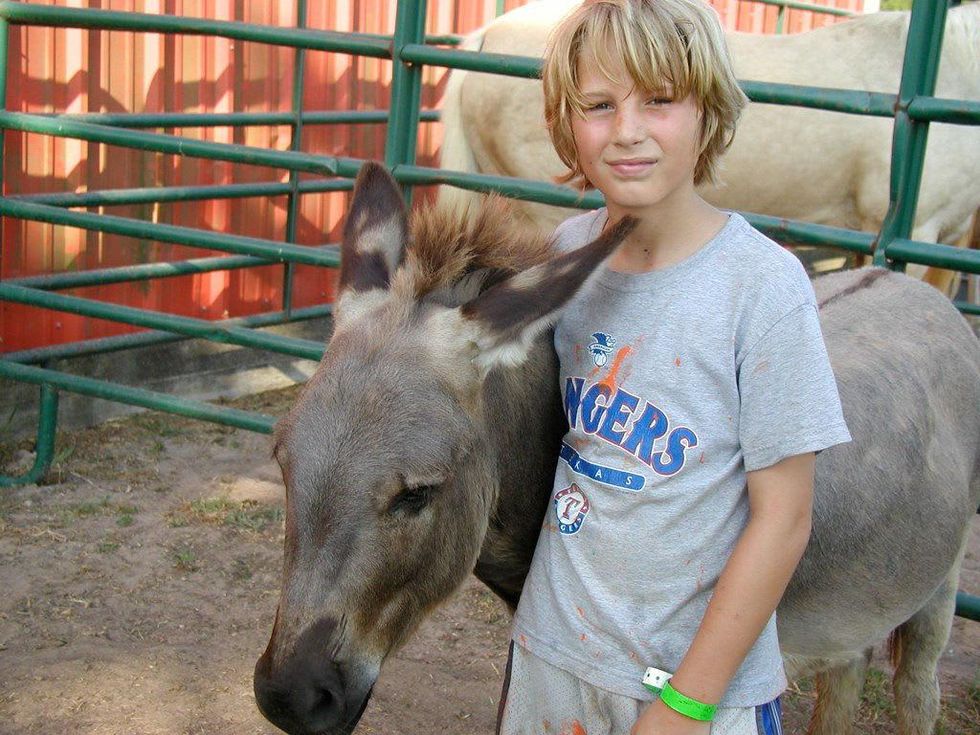 Child volunteering at equine therapy center in Houston