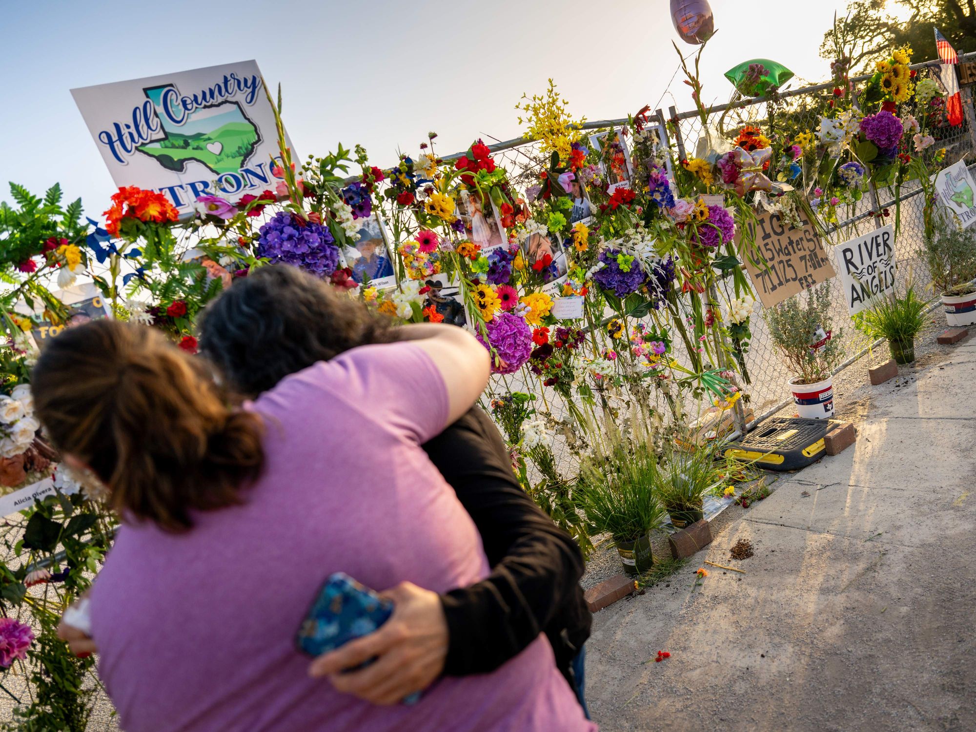 Community residents grieve and pay their respects at a memorial on July 10, 2025 in Kerrville, Texas