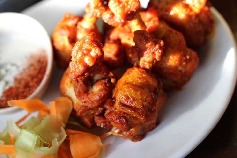 Crispy buffalo wings with a carrot and celery slaw.