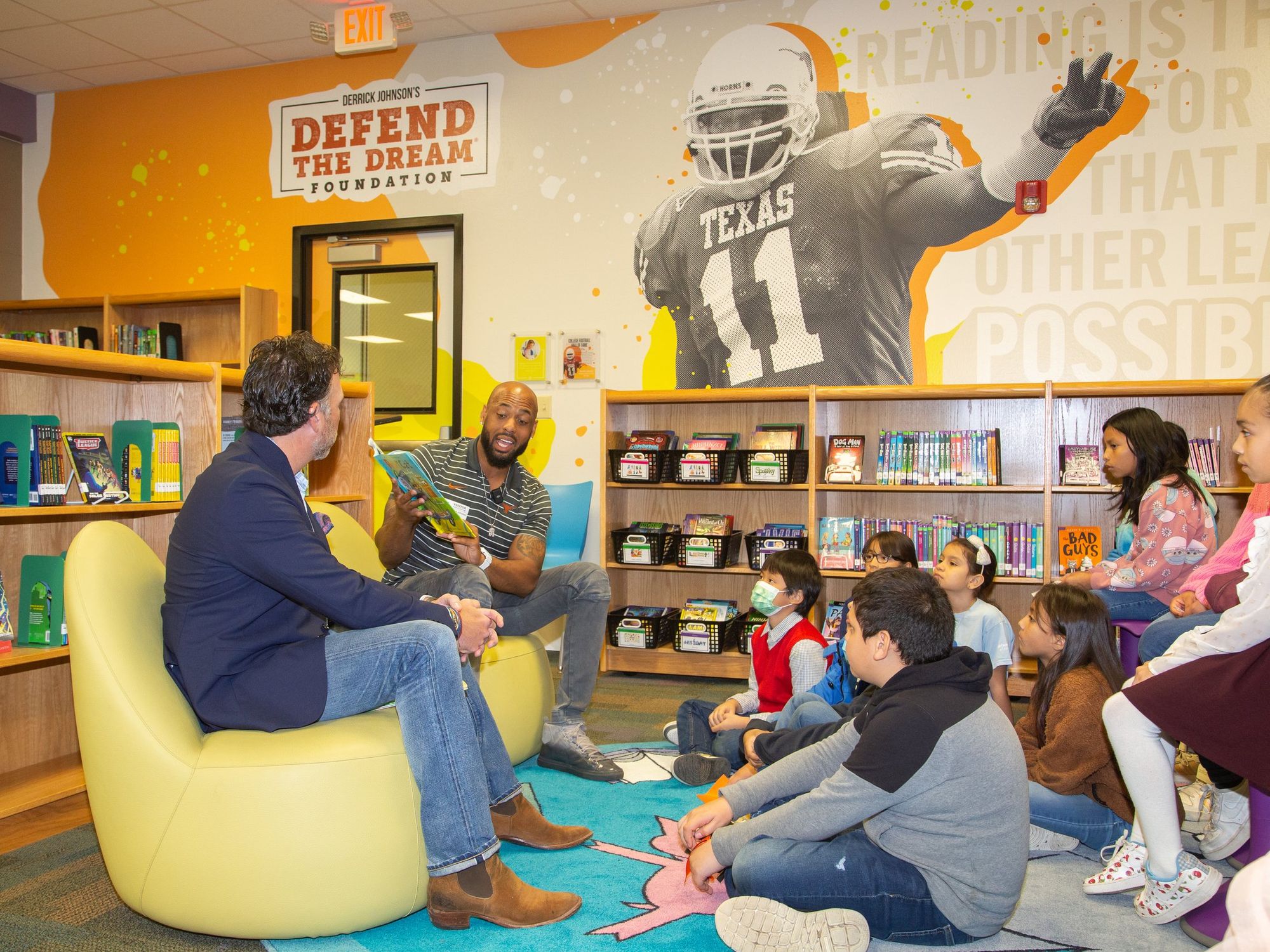 Derrick Johnson reads to kids at his Langford Elementary School Discovery Den.