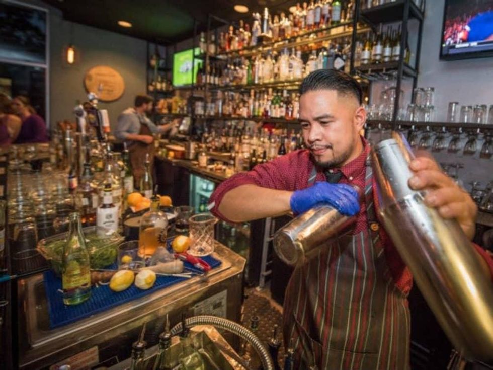 District Kitchen + Cocktails bartender shaking drink