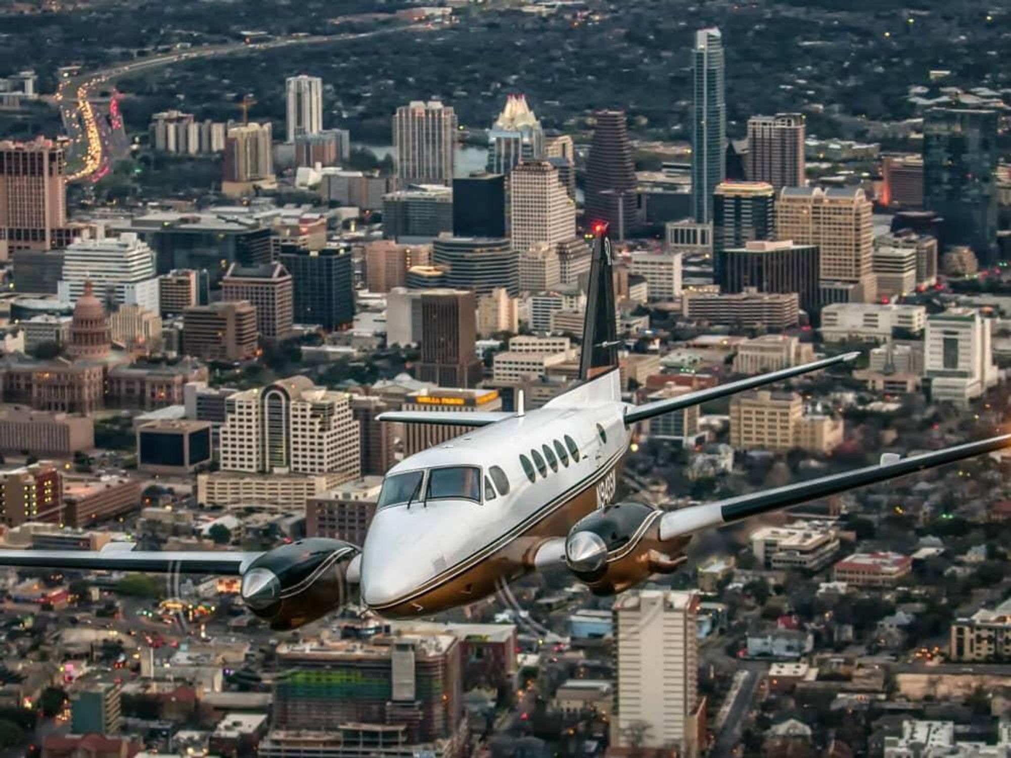 Envi Airways plane jet Austin downtown skyline