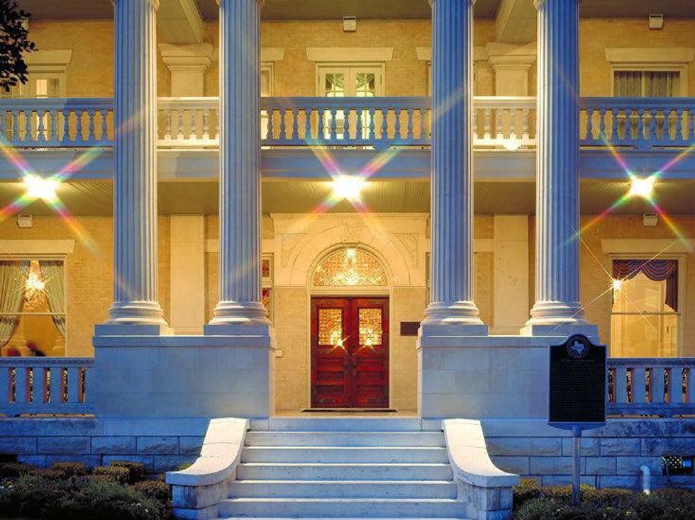 Exterior front door of Hotel Ella lit up at night
