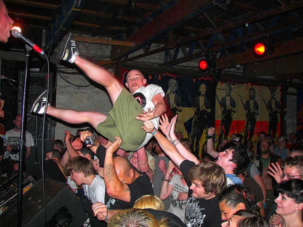 Fan crowd surfs at a Chaos in Tejas show in 2009