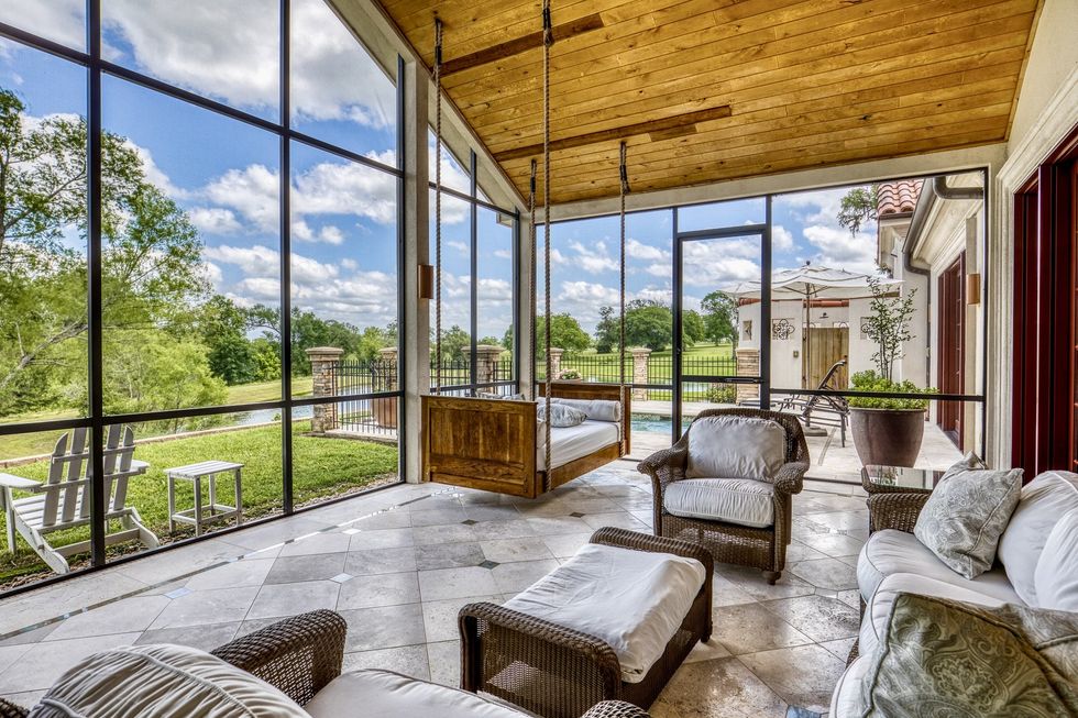 Floor-to-ceiling windows showcase the beauty of Texas nature.