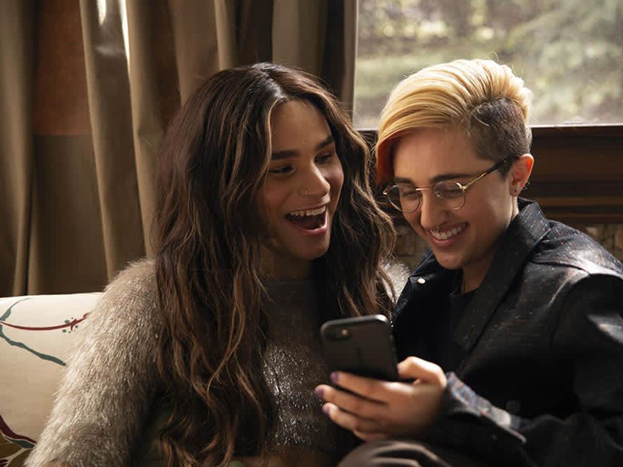 Friends laughing at cell phone