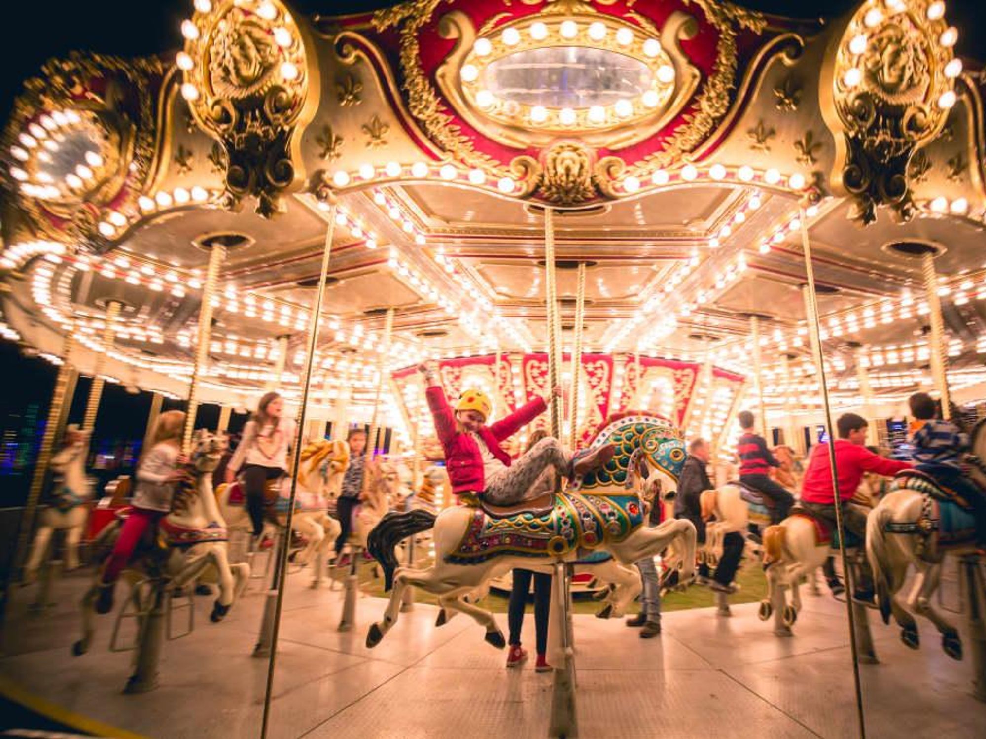 Girl riding a carousel at Austin Trail of Lights