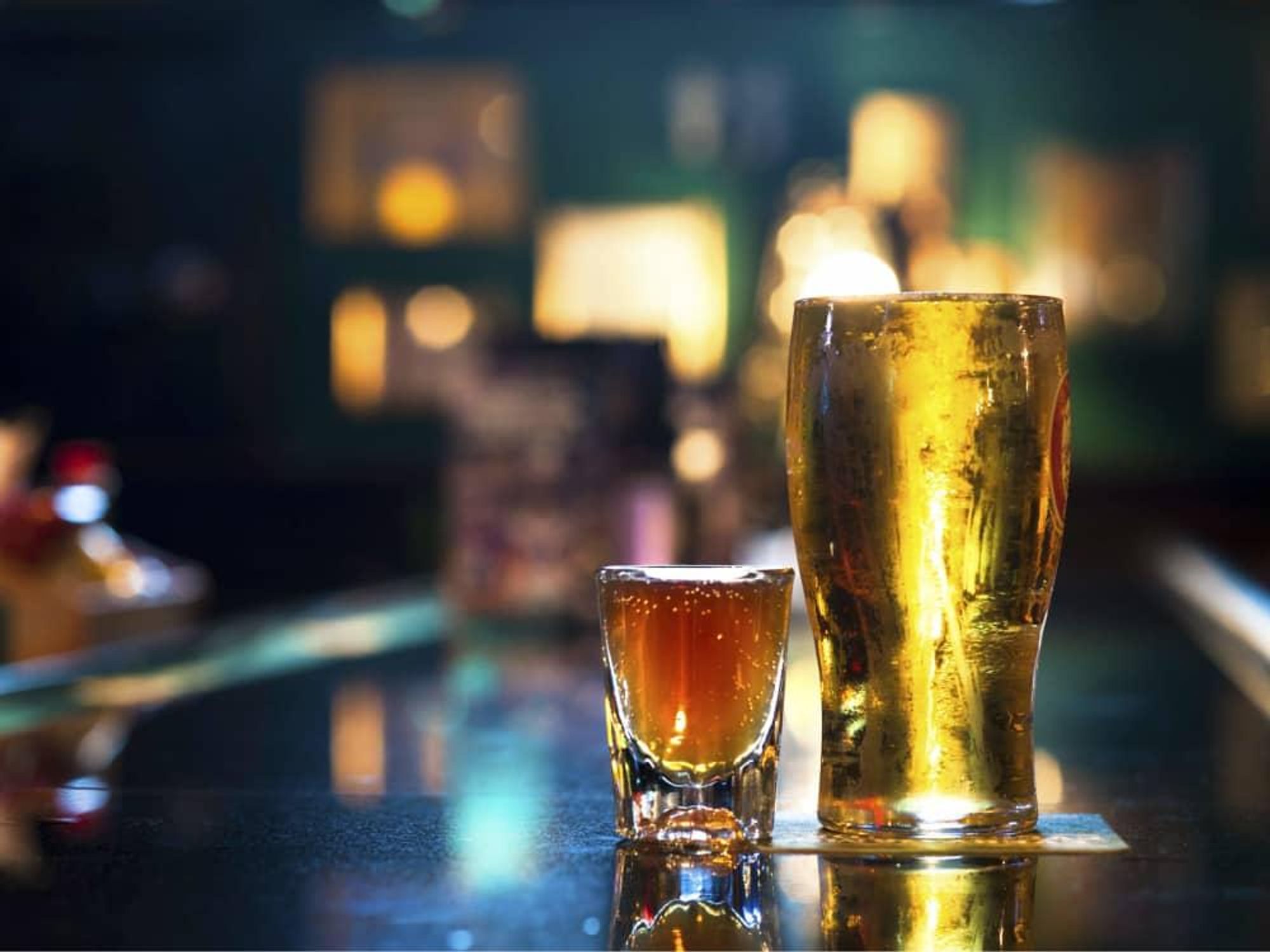 Glass of beer and a shot on a bar