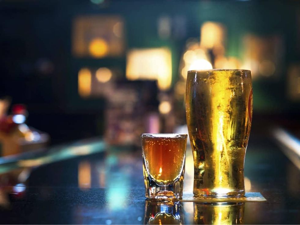 Glass of beer and a shot on a bar