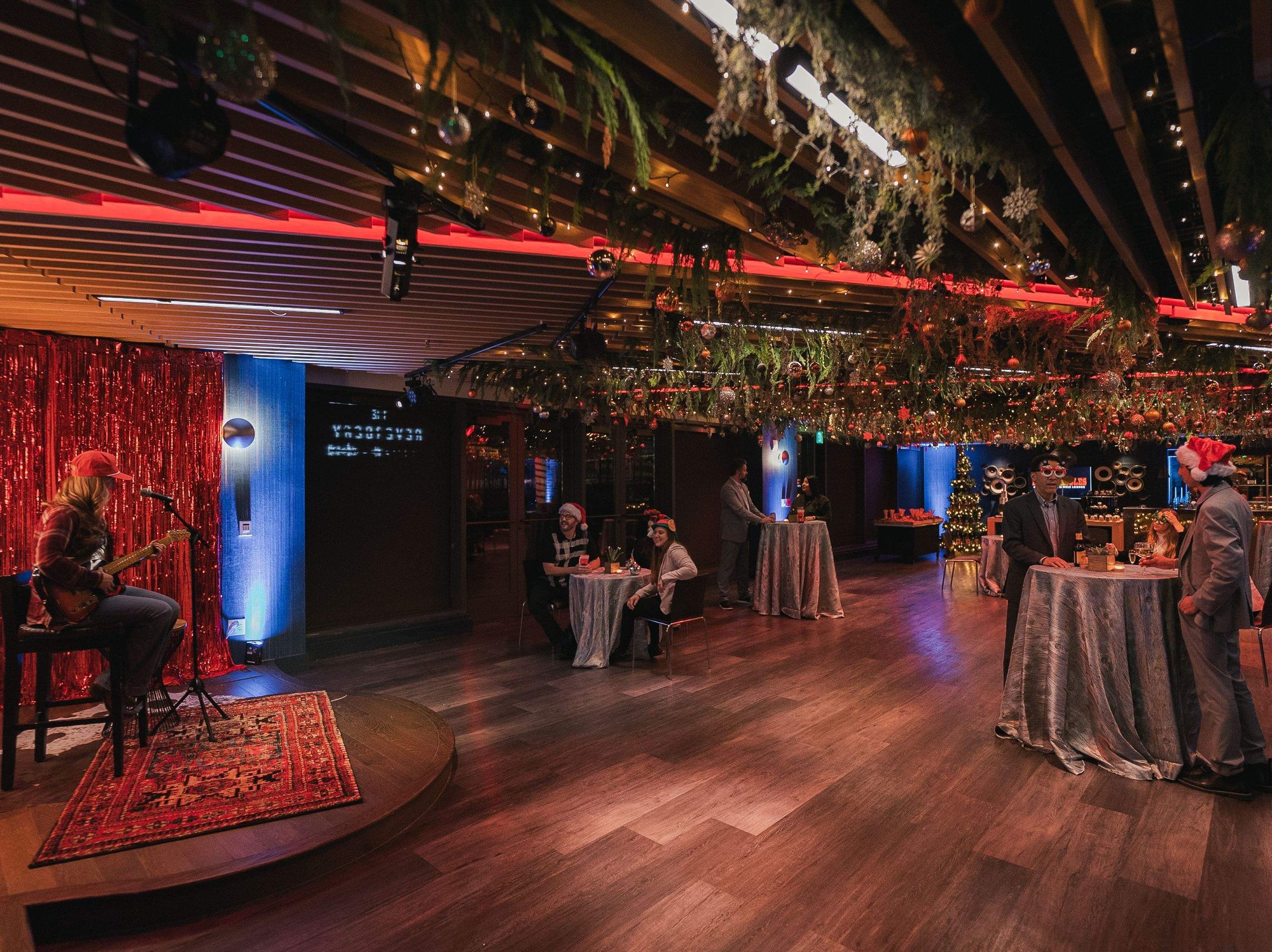 Guests listen to live music in a Christmas-themed Mr. Bo-Jingles Bar at the Hilton Austin.