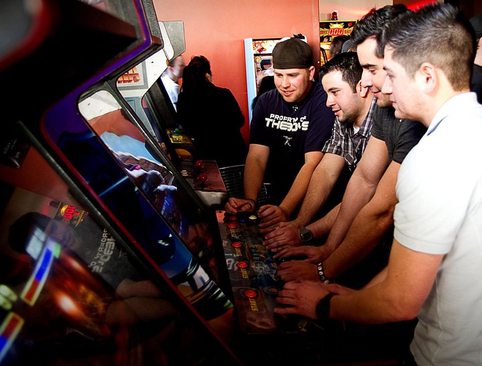 Guys playing games at Kung Fu Saloon
