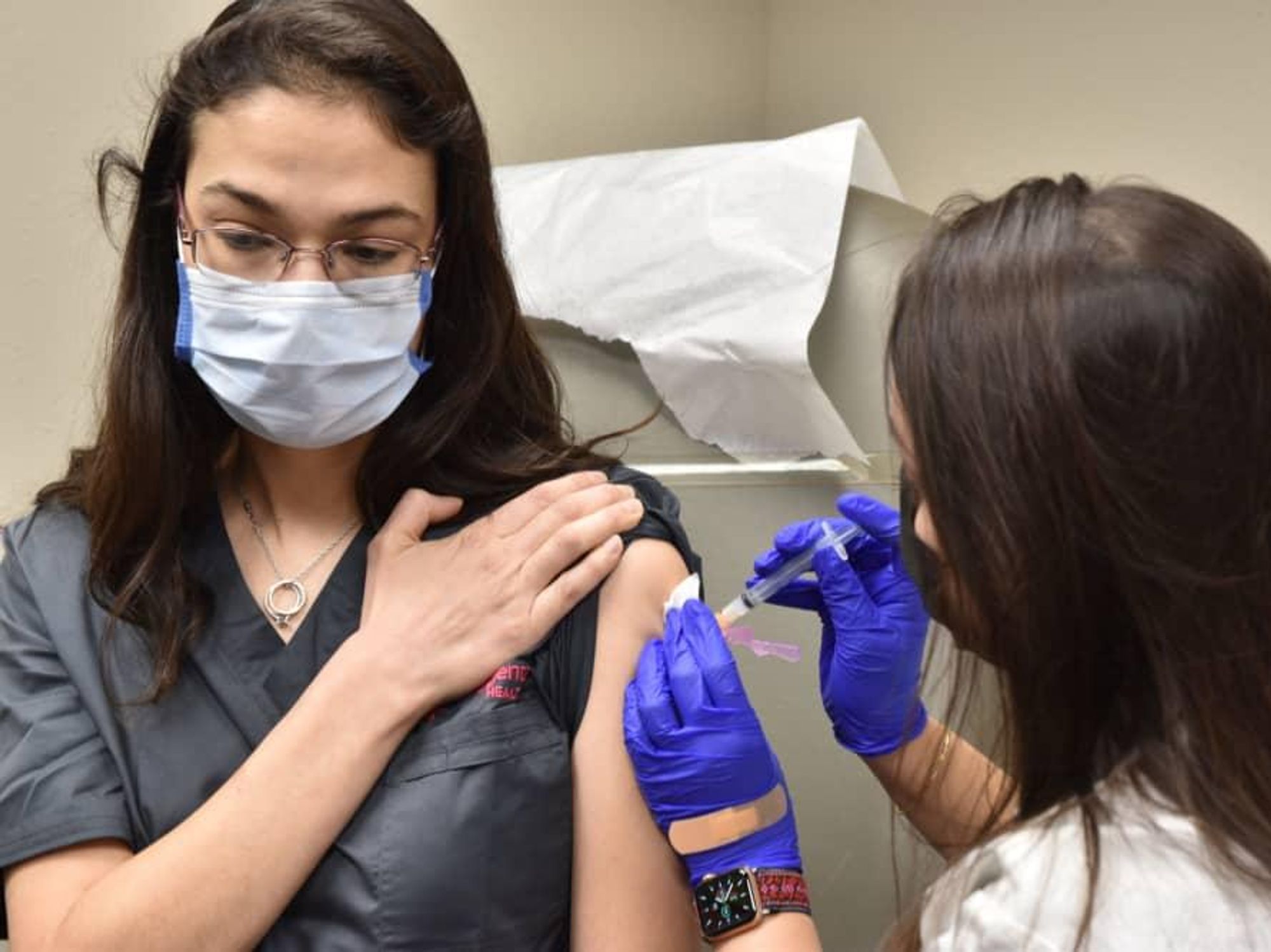H-E-B woman getting covid-19 vaccine shot healthcare worker