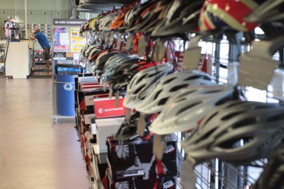 Helmets hang on the walls at Performance Bike