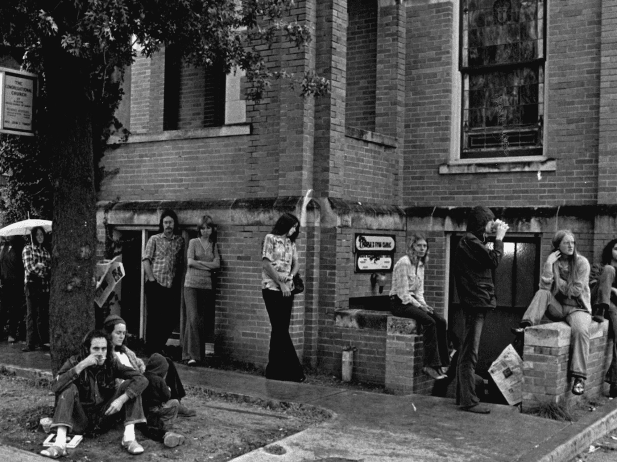 Historical photo of patients waiting in line at the People's Free Clinic in Austin