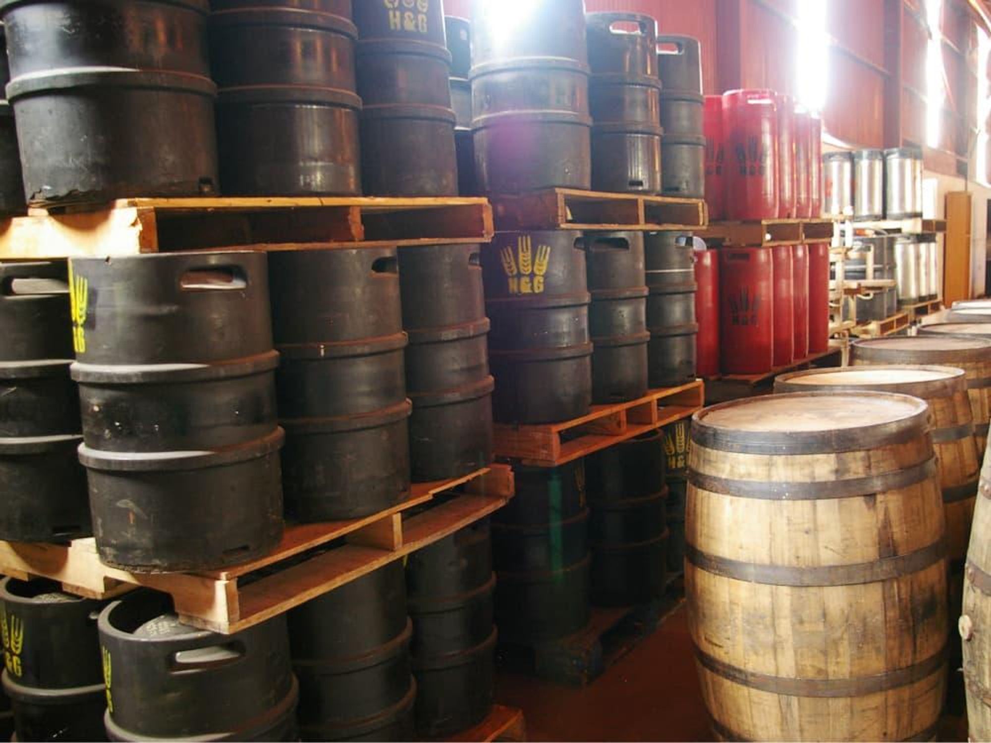 Hops and Grain brewing storage with barrels and kegs