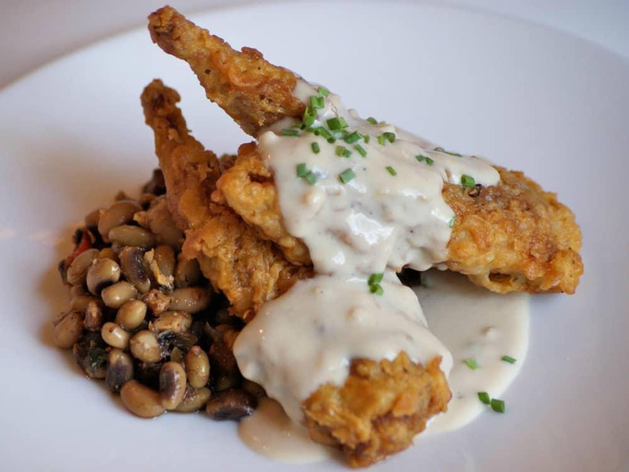 Hudson's on the Bend Austin resaurant Southern fried quail black eyed peas dish food