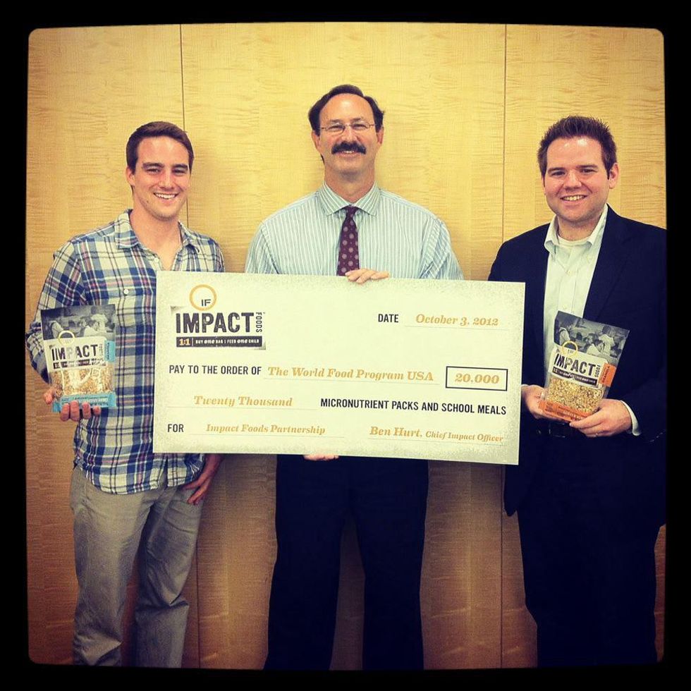 Impact Foods founders Ben Hurt and Blaine Iler delivering a check to the World Food Program
