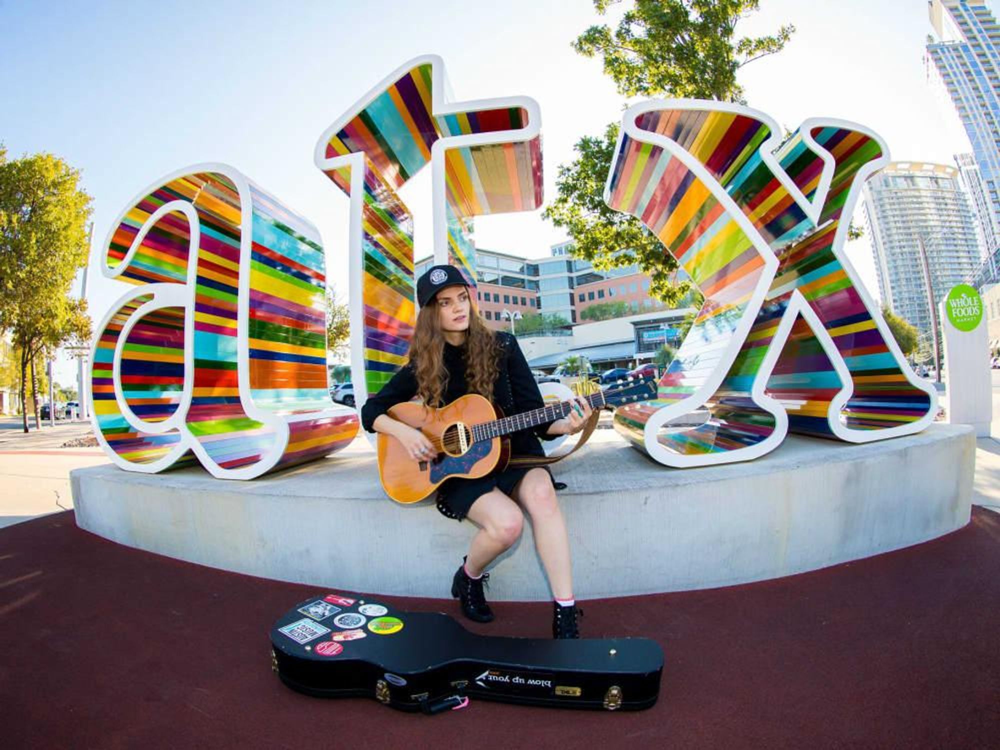 Jane Ellen Bryant performs at HAAM Benefit Day ATX sign