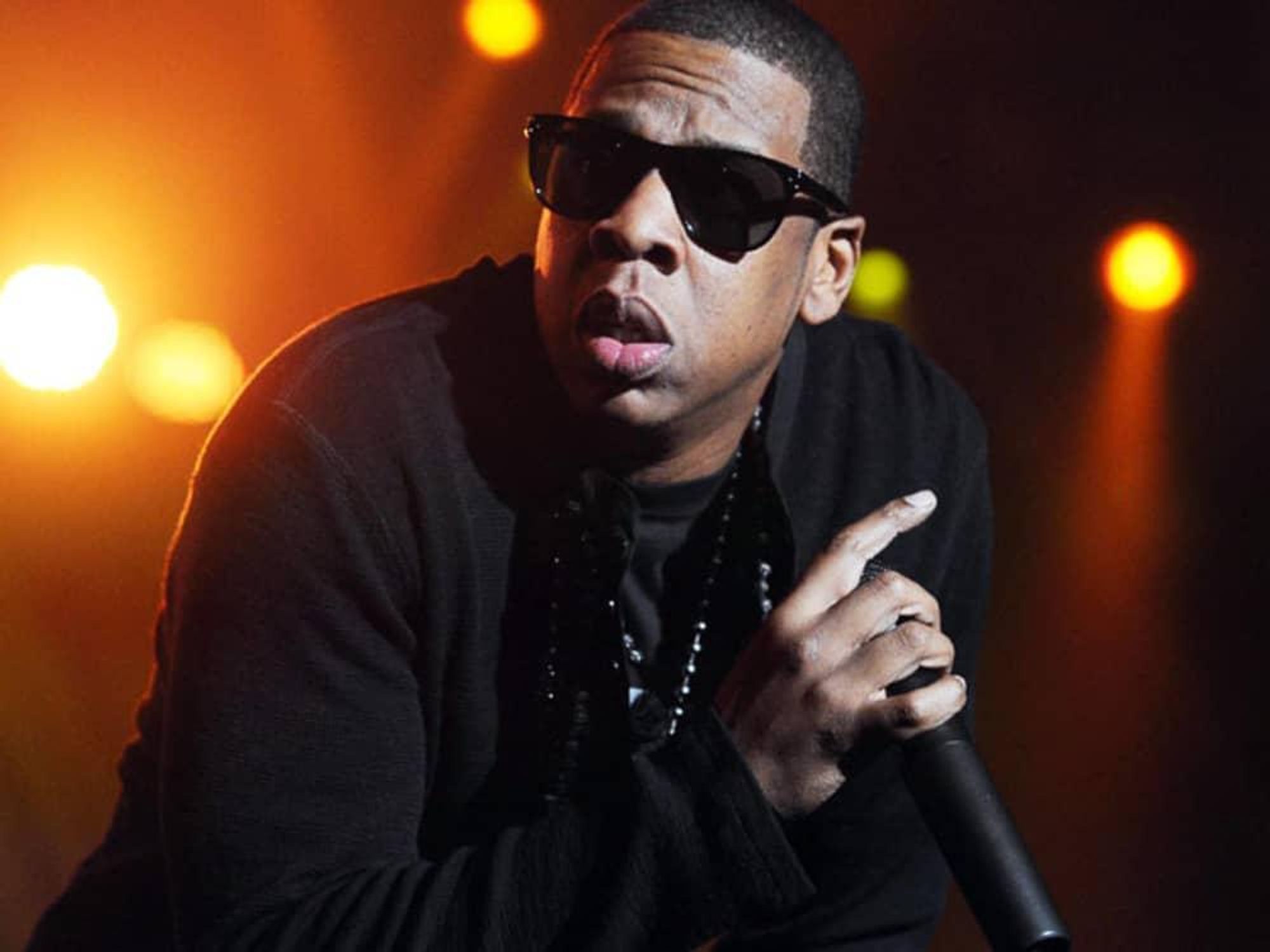 Jay-Z, with mic, sunglasses