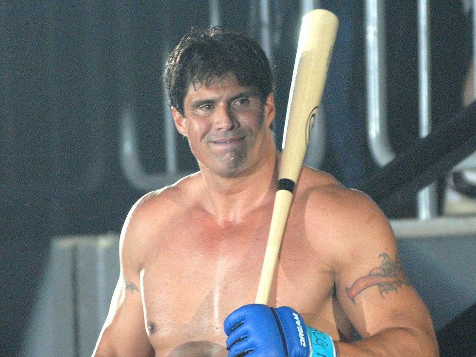Jose Canseco in boxing gloves with baseball bat
