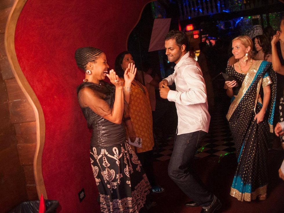 Joy Scott dances with friends in a velvet tunnel at Bollywood Ball