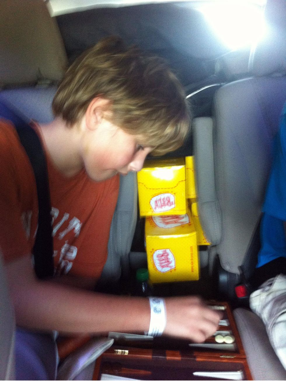 Kid playing backgammon in the car