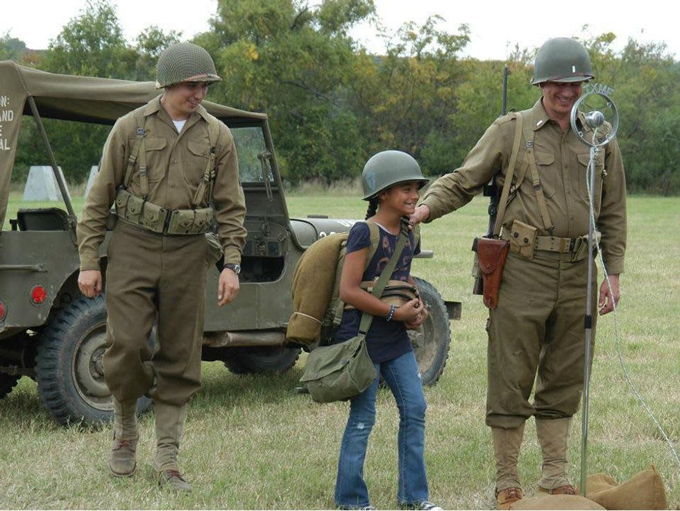 Kid with reenactors of World War II at Camp Mabry for Texas Military Forces Museum