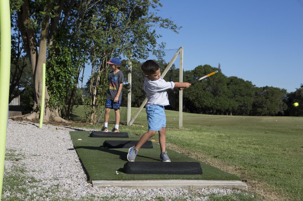 Little boy swinging golf club