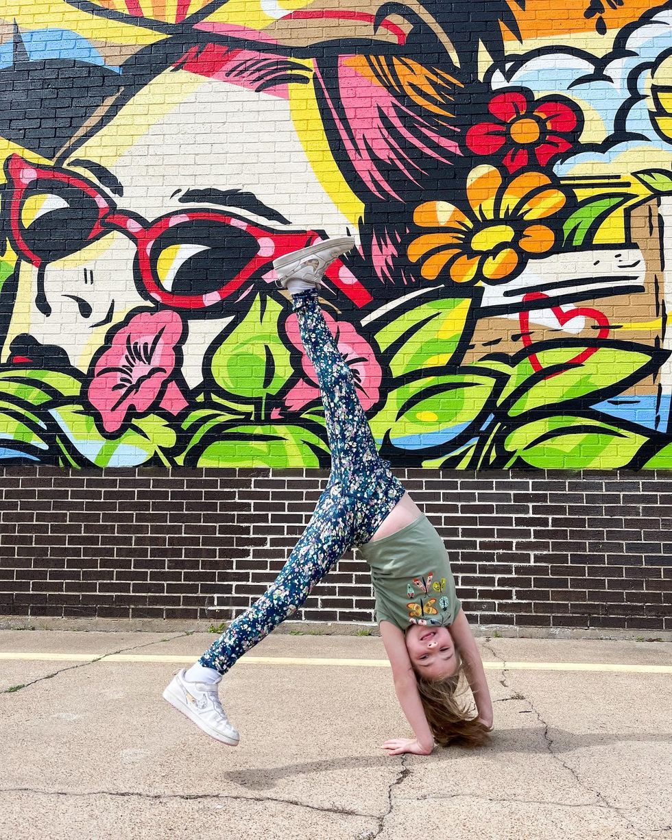 Little girl in front of mural in Beaumont