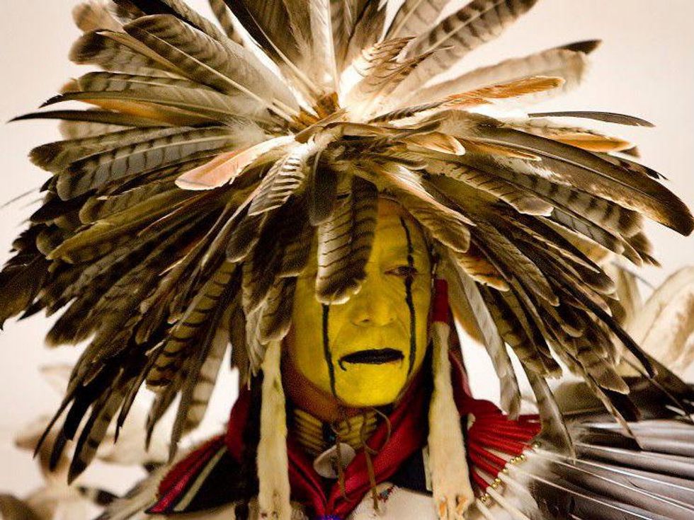 Man in ceremonial headdress and attire for Austin Powwow and American Indian Festival