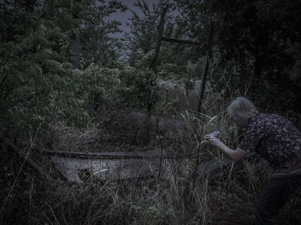 Marshall Hinsley searching the debris of an old barn