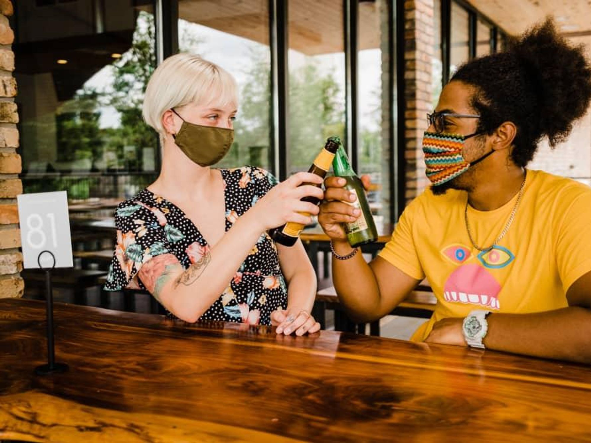 Masked people having a beer